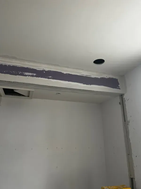 There is a hole in the ceiling in the middle of the room.