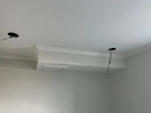 There is a ceiling fan hanging from the ceiling of a room.