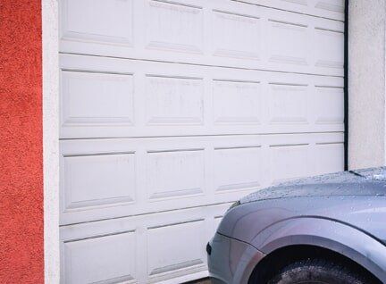 Residential Garage Door — Garage Door and Car in Lomita, Garage Door Repair — Man Fixing Garage Door in Lomita, CA