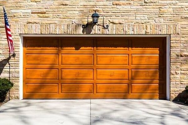 Residential Garage Door — Wooden Garage Door with Flag on Side in Lomita, CA