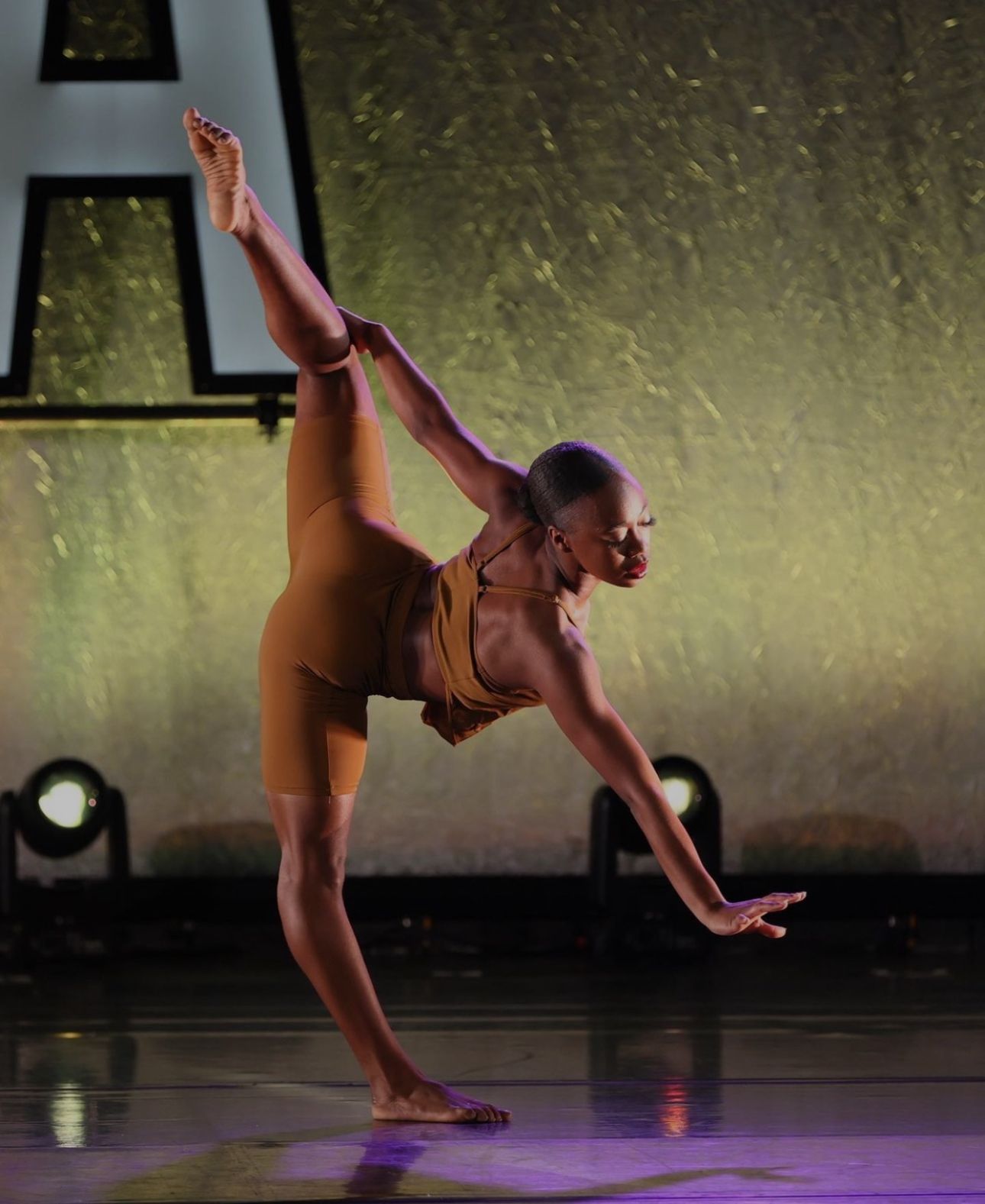 A woman is doing a split on a stage.