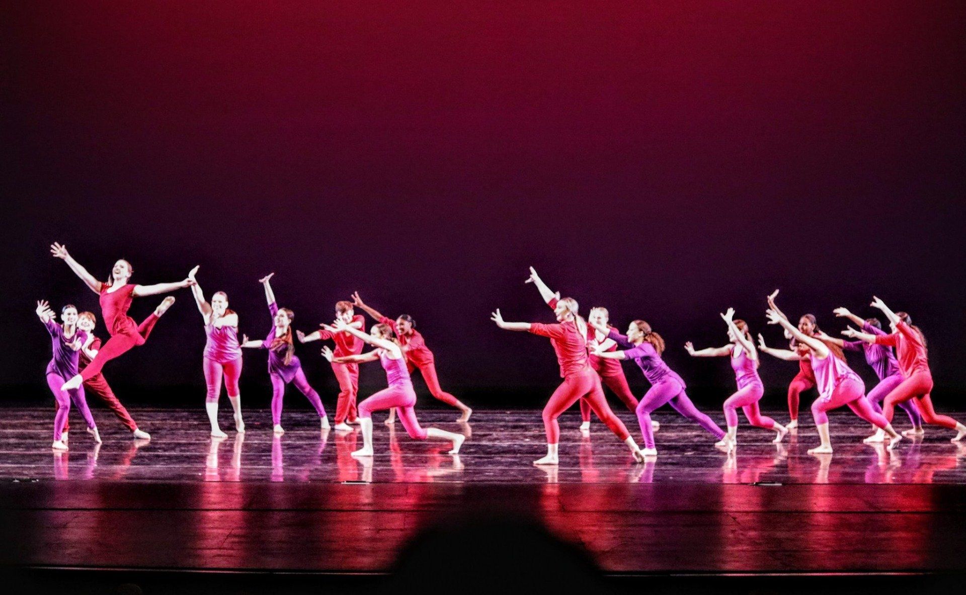 A group of dancers are performing on a stage.