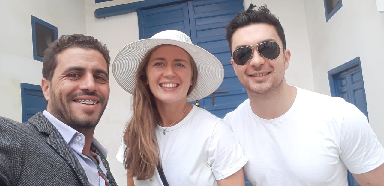 A breathtaking view of Bahia Palace's grand courtyard, featuring intricate tile work, arched doorways, and lush greenery, under a clear blue sky.