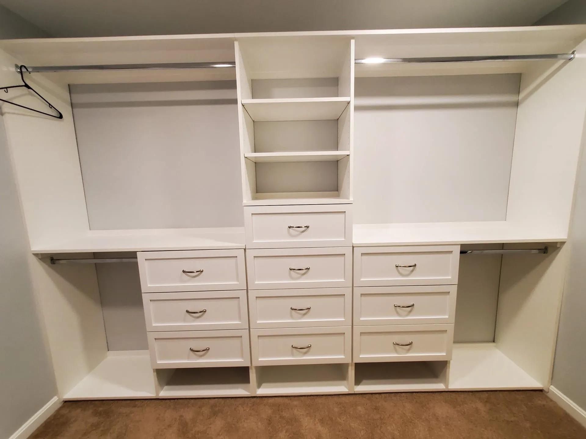 A walk in closet with lots of drawers and shelves