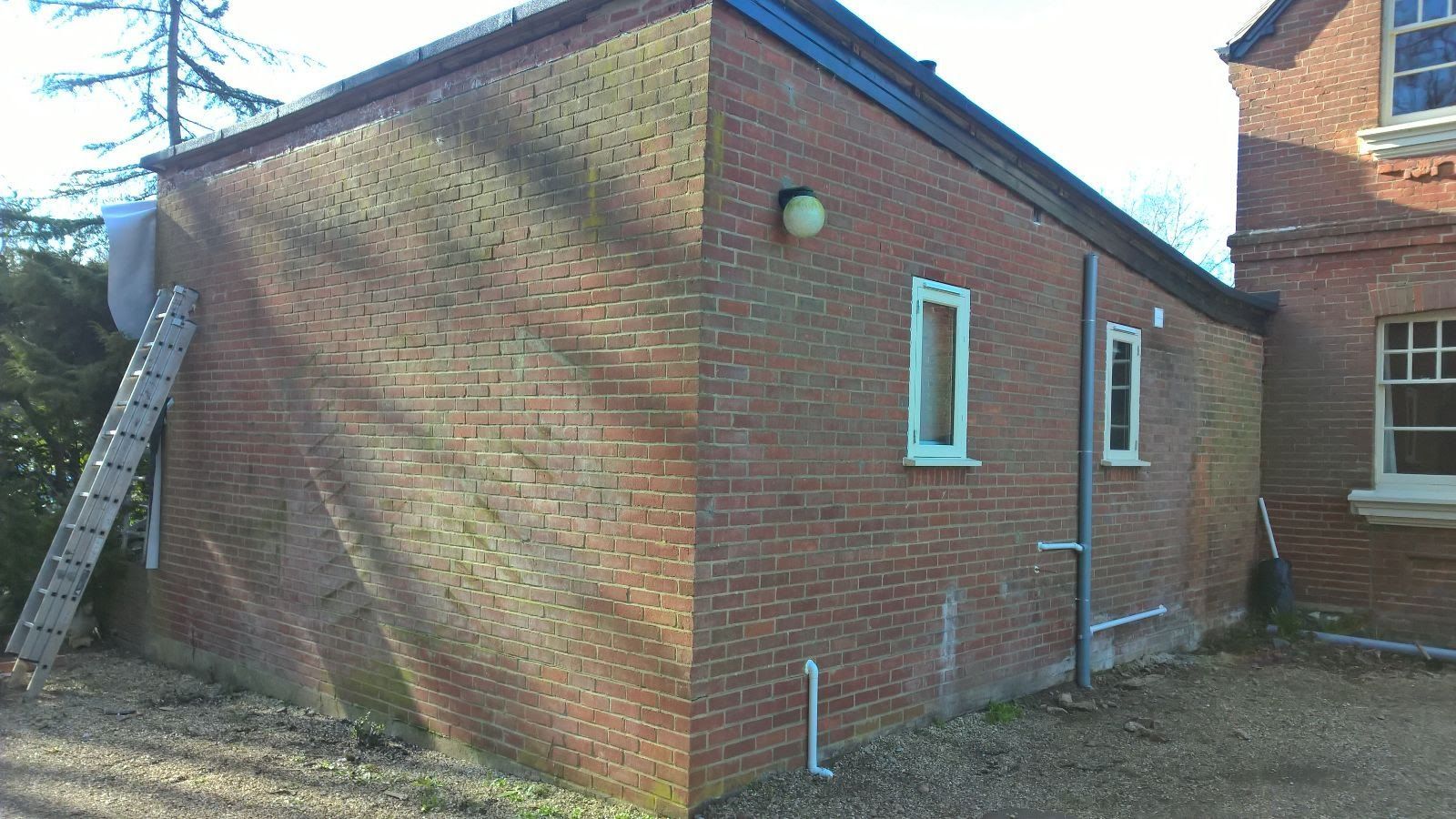 A brick building with a ladder leaning against it