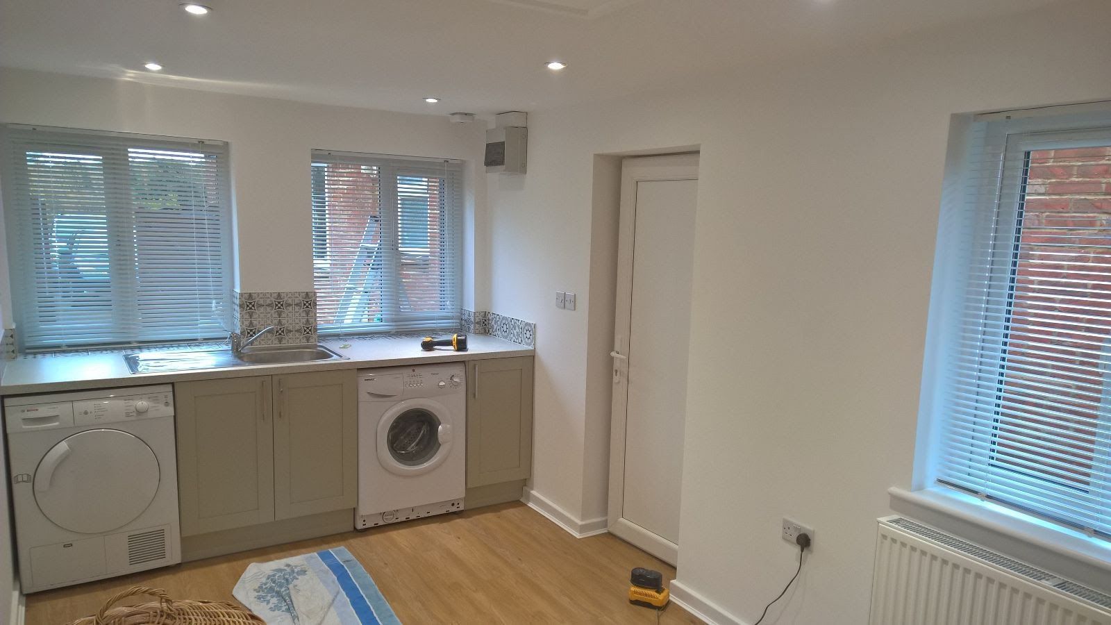 A kitchen with a washing machine , dryer , and dishwasher.
