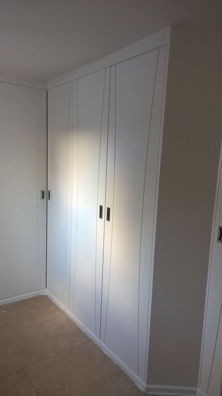 There are a lot of white cabinets in this room.