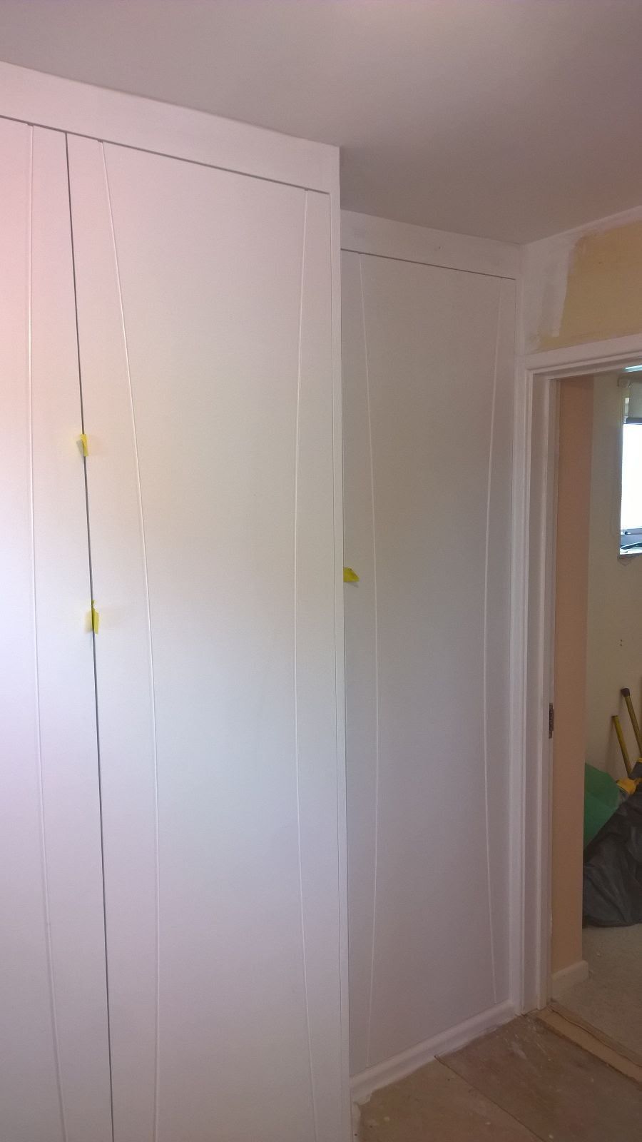 A room with white walls and a door that is open.