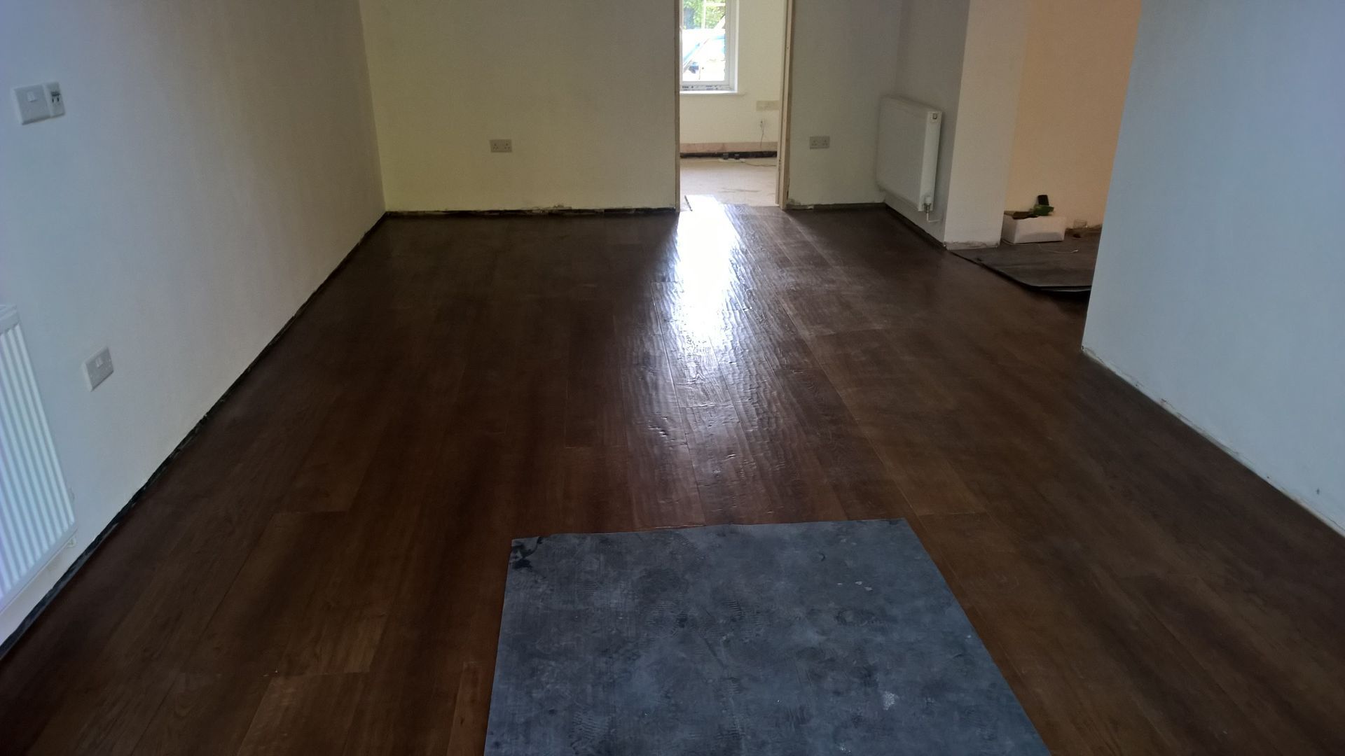 There is a rug on the floor in the middle of the room.