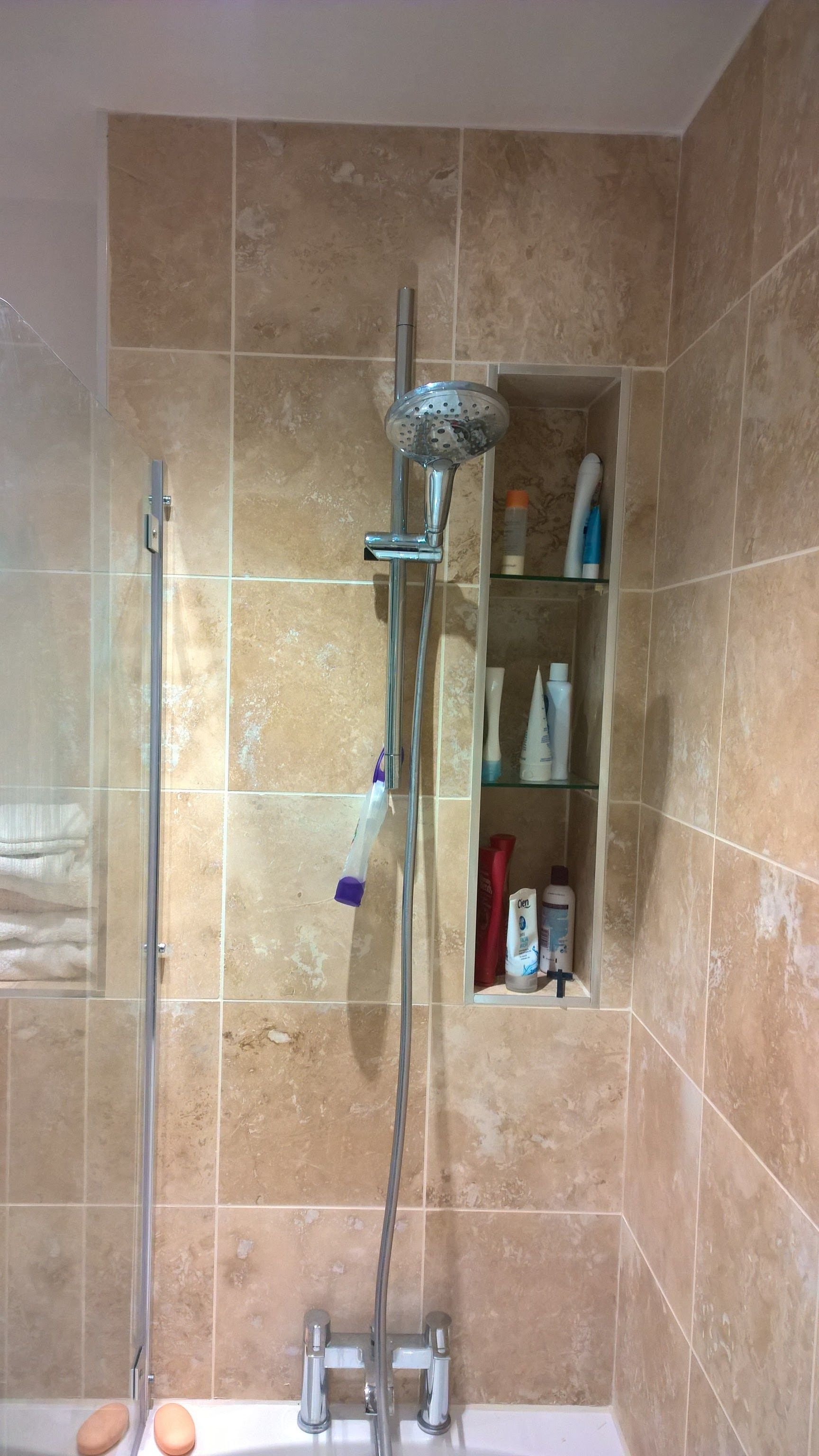 A bathroom with a shower head and a bathtub.