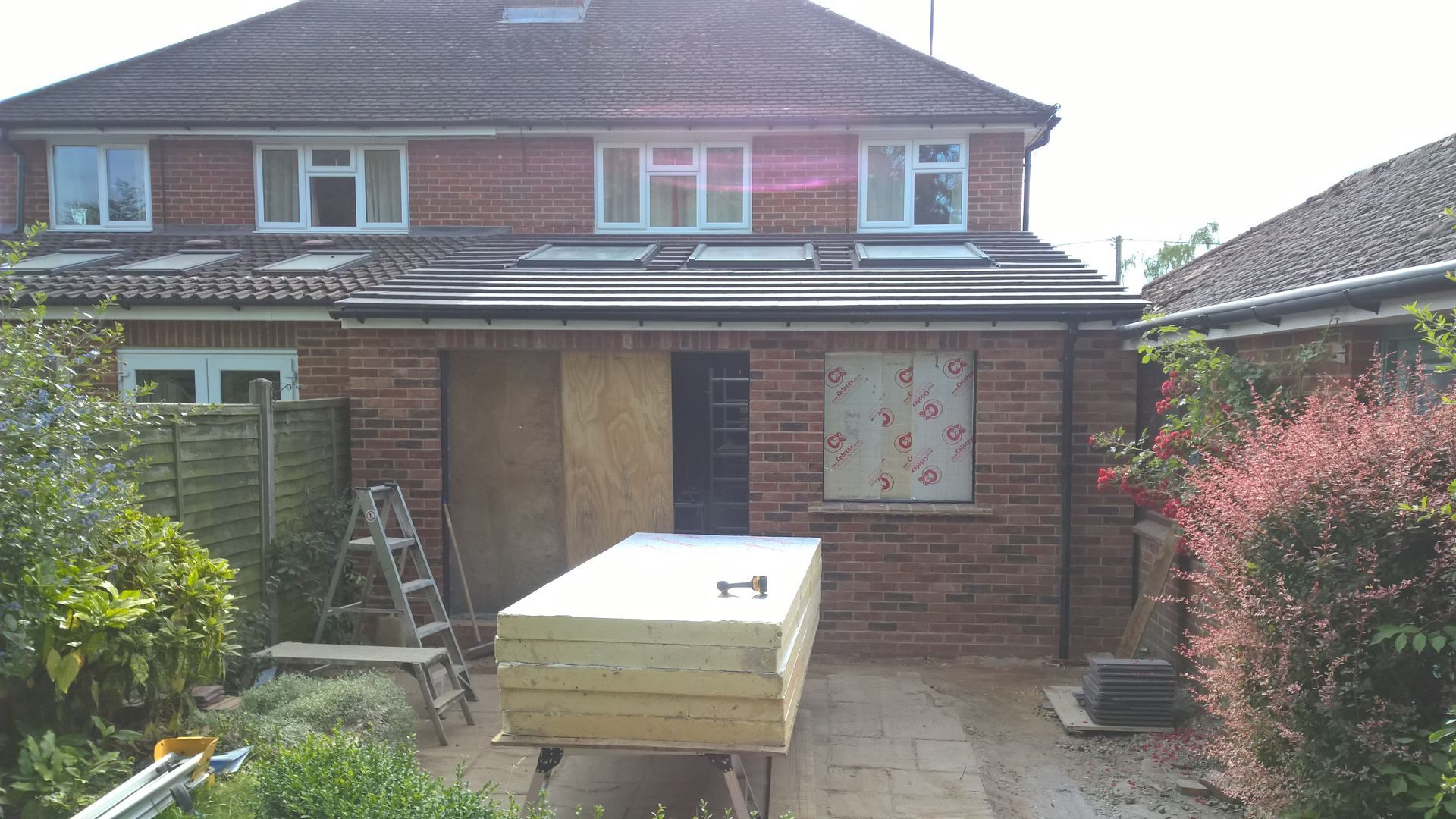 A brick house with a wooden table in front of it