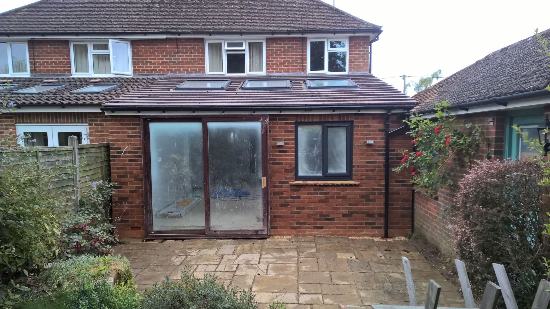 A brick house with a patio in front of it