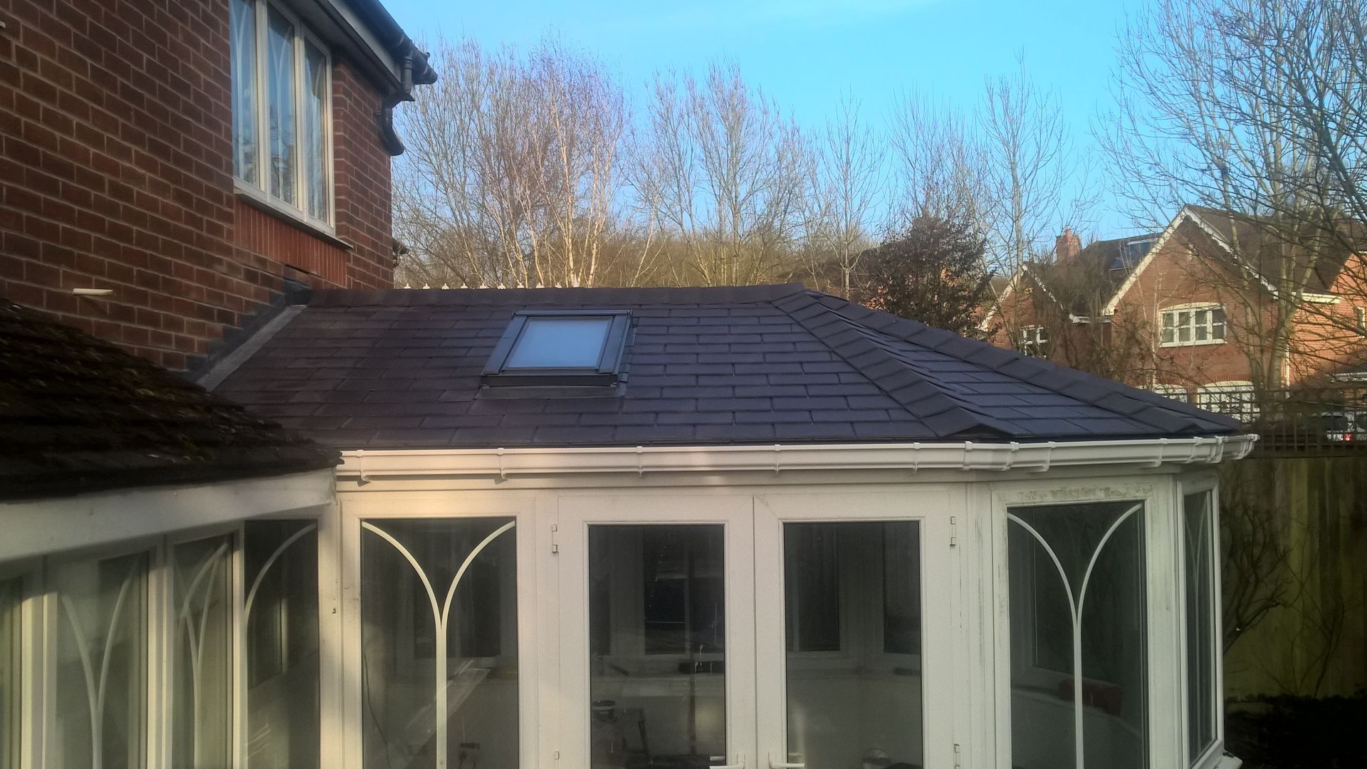 A house with a roof that has a skylight on it.