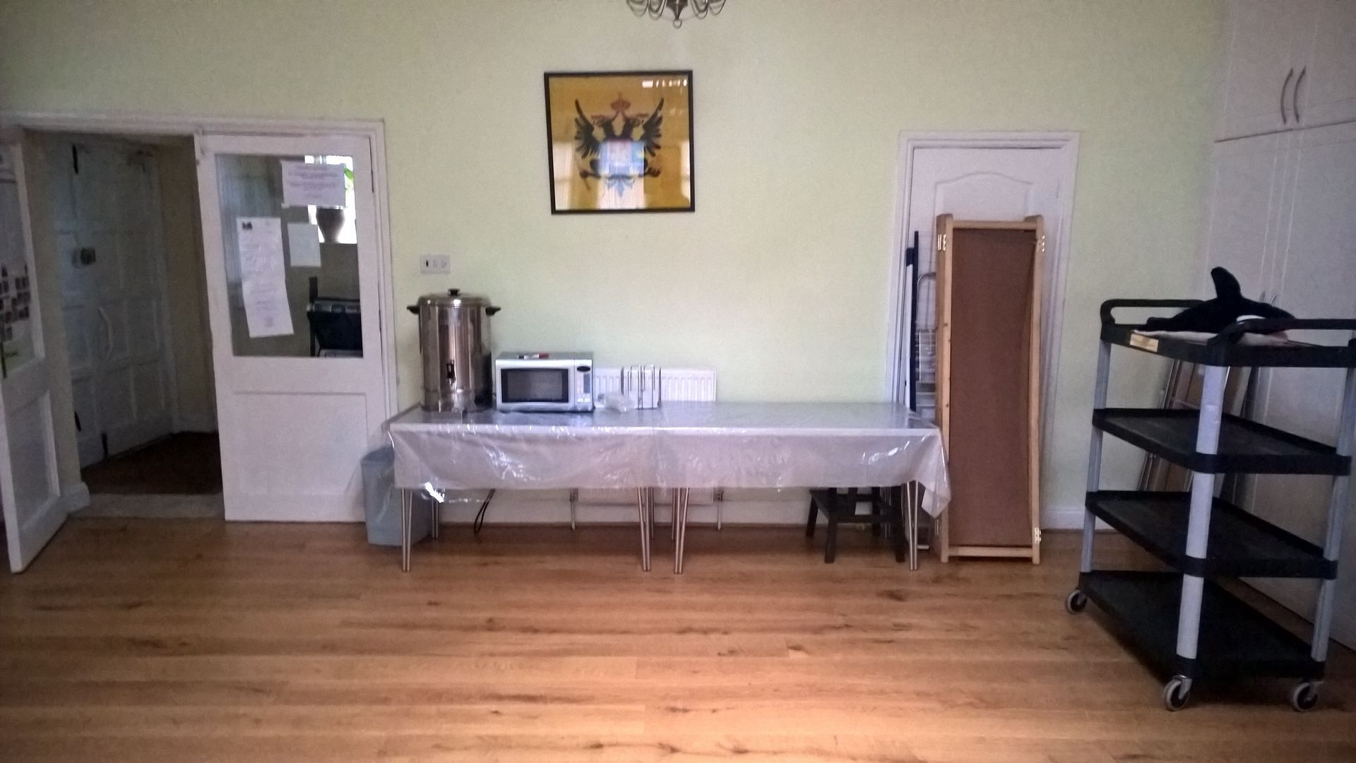 A room with a table and a picture on the wall