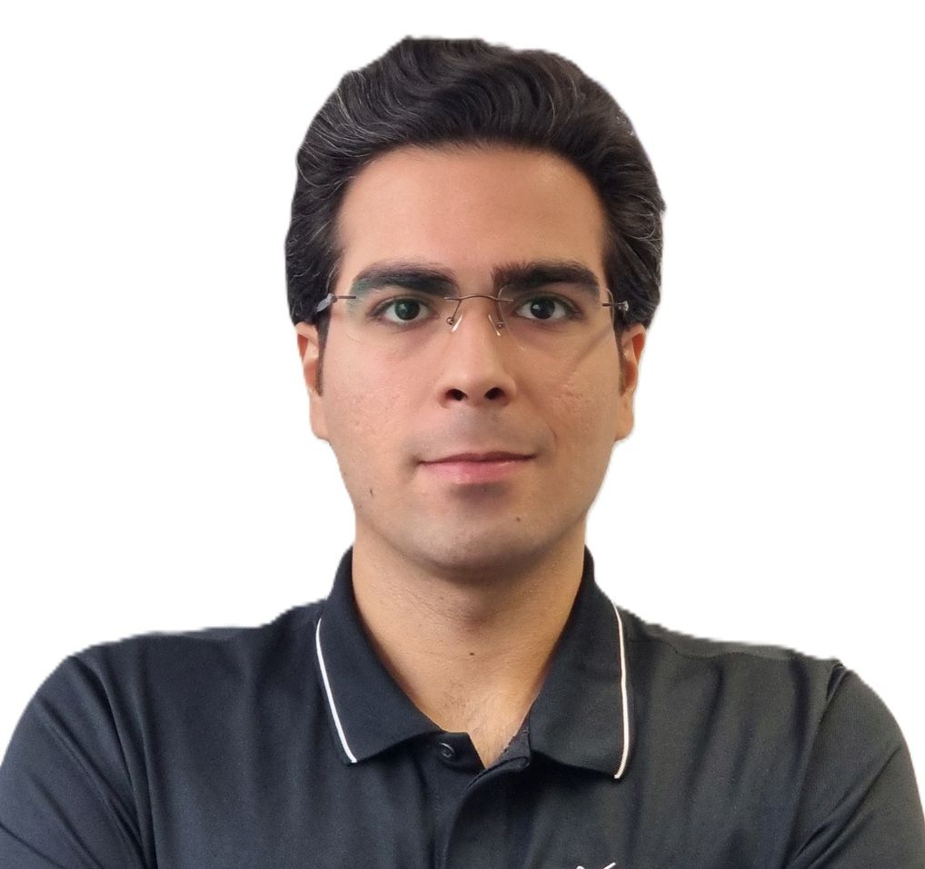 Mark, a Sports Therapist at Total Massage Clinic, is wearing glasses and a black collared shirt with white trim, looking confidently at the camera against a plain white background.