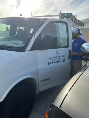 Man getting out of a white work van labeled