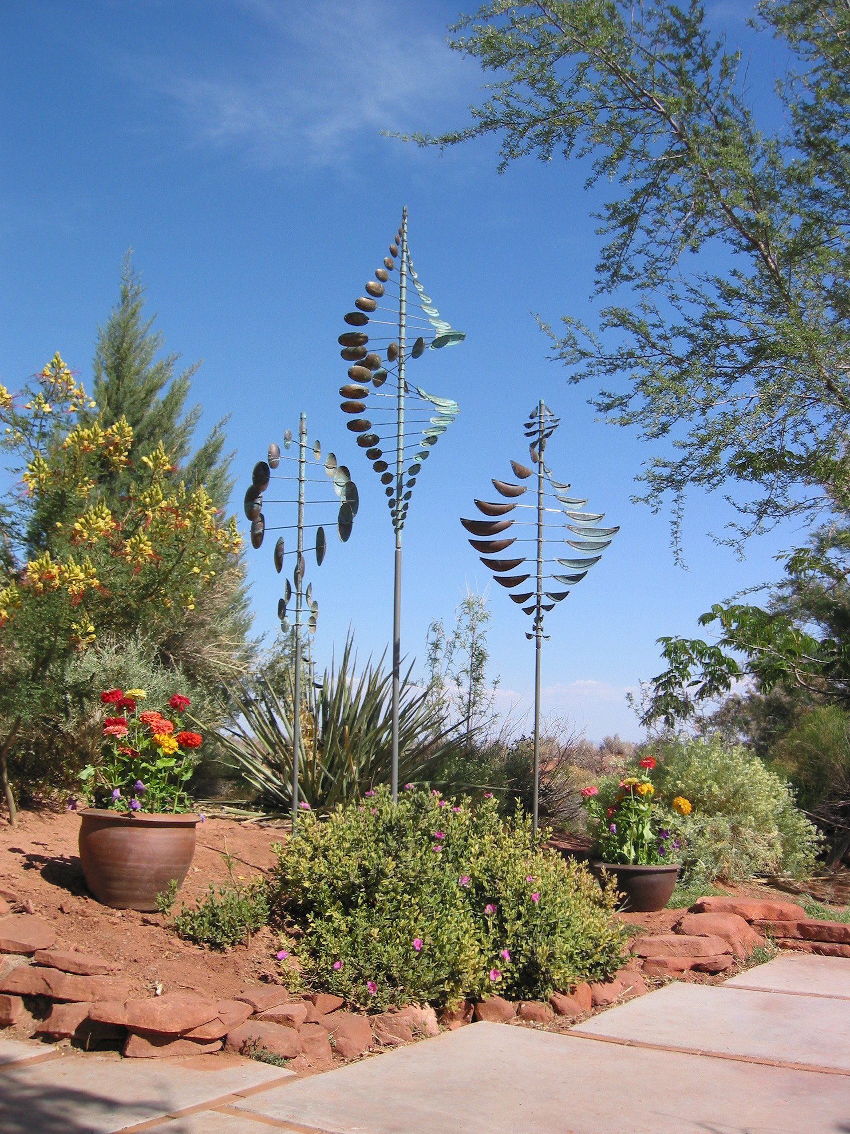Three Wind sculptures in a garden