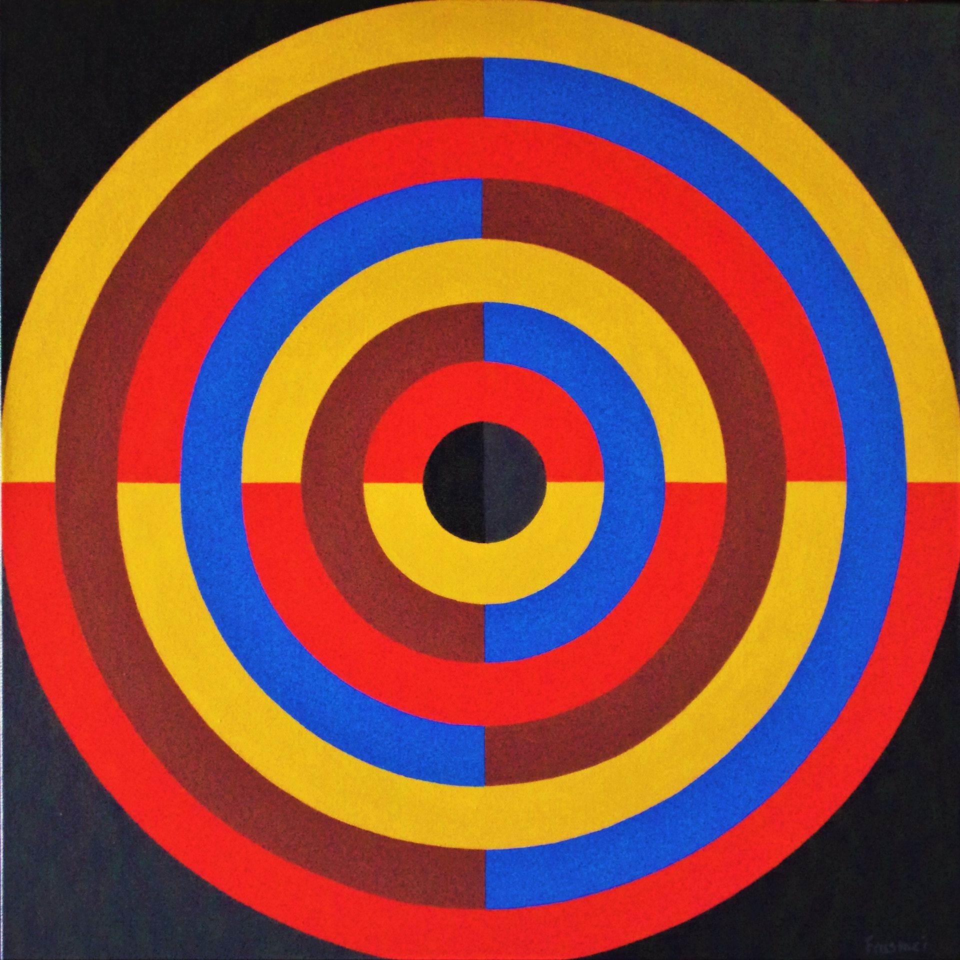 A red yellow and blue circle with a black center
