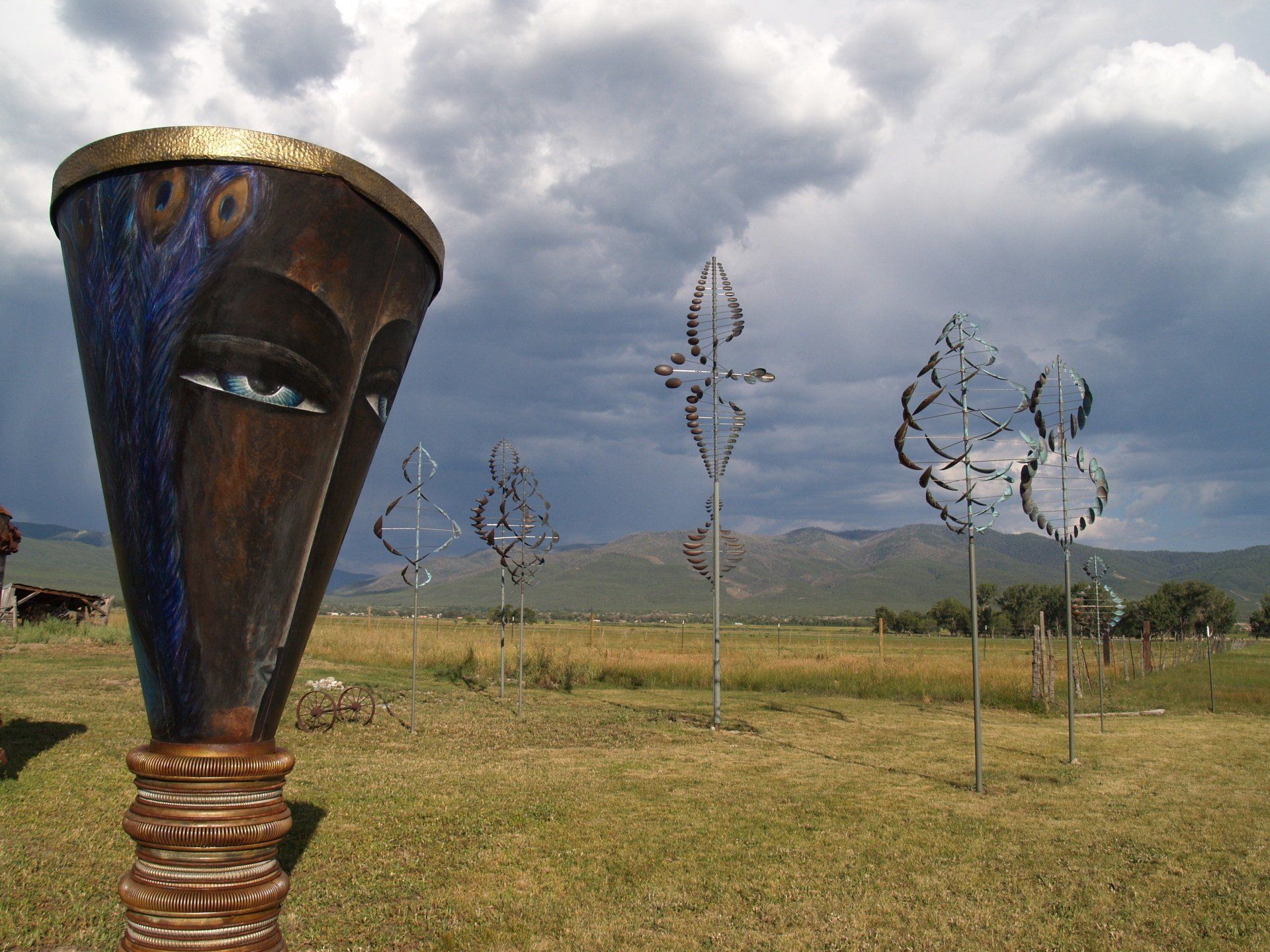 Large Garden Sculpture with eyes wind sculptures in background
