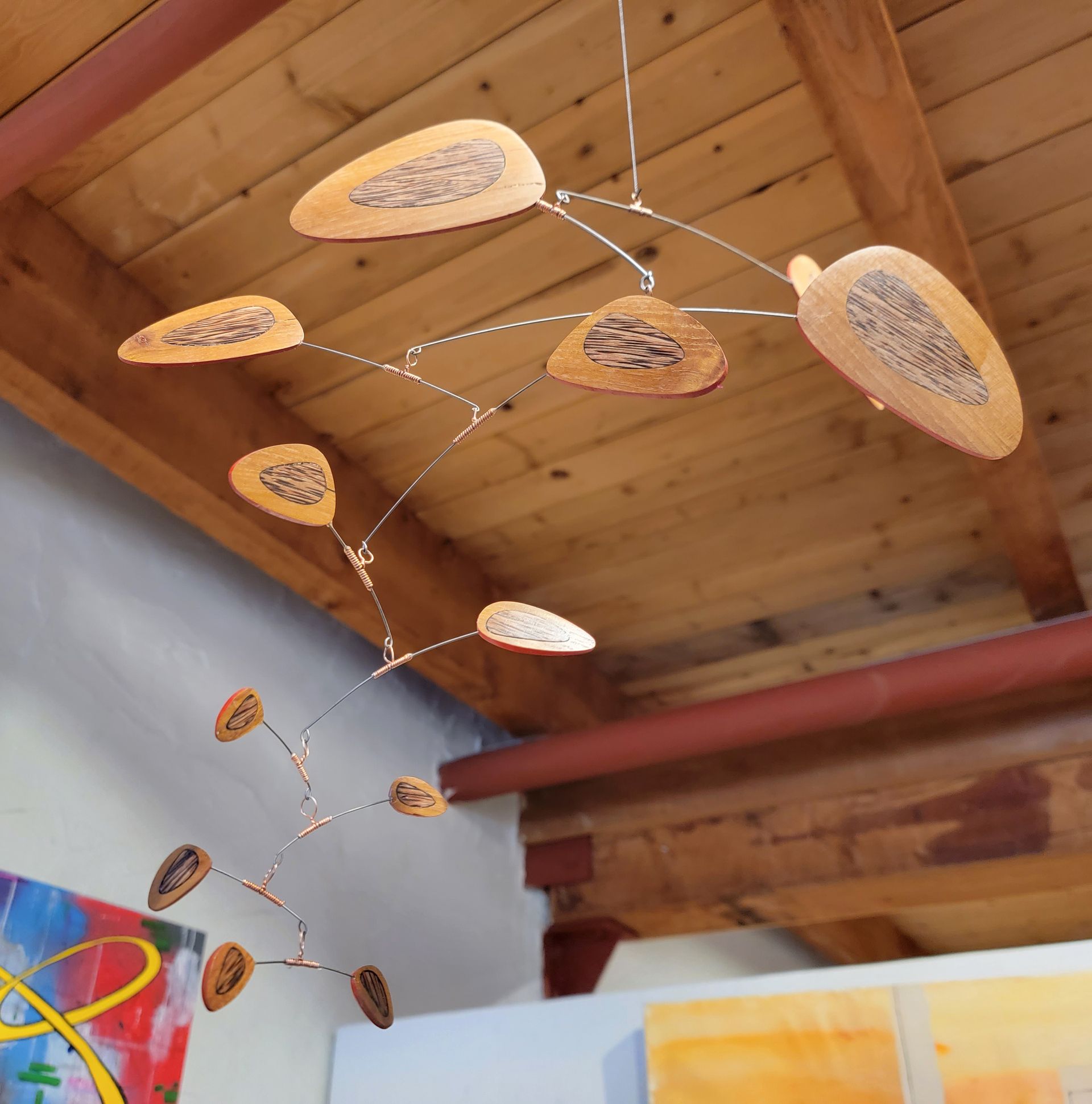 A mobile is hanging from the ceiling in a room