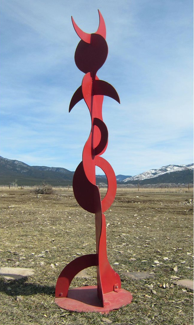large red metal sculpture by steve ebben, buffalo dancer