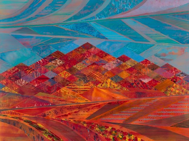 Colorful mosaic-like mountain range with blue-patterned sky over an orange desert landscape.
