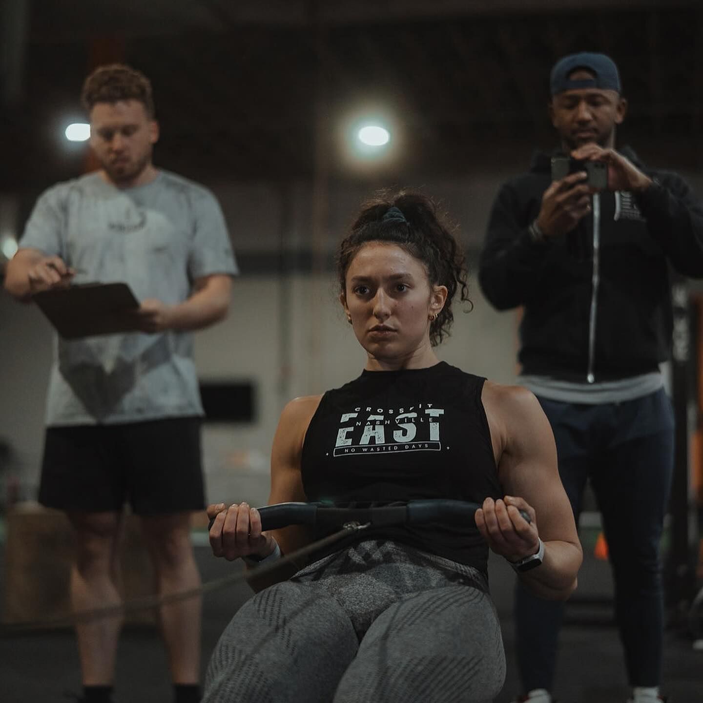 A woman wearing a black tank top with the word fast on it