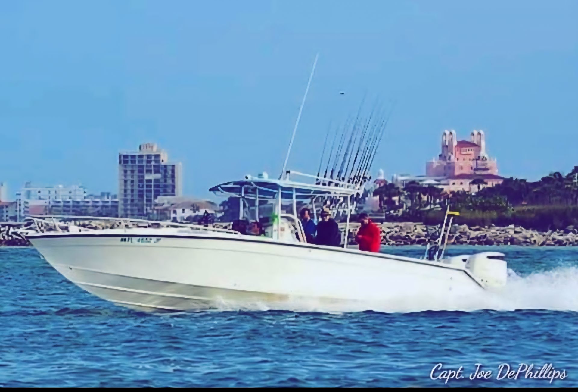 White fishing boat on blue water, city skyline background.