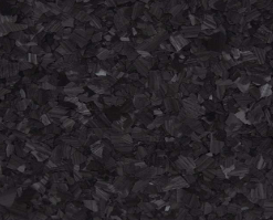 Close-up of black carbon fiber flakes, creating a textured, dark surface.