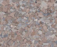 A close-up view of a speckled surface with patches of pink, tan, and blue colors.