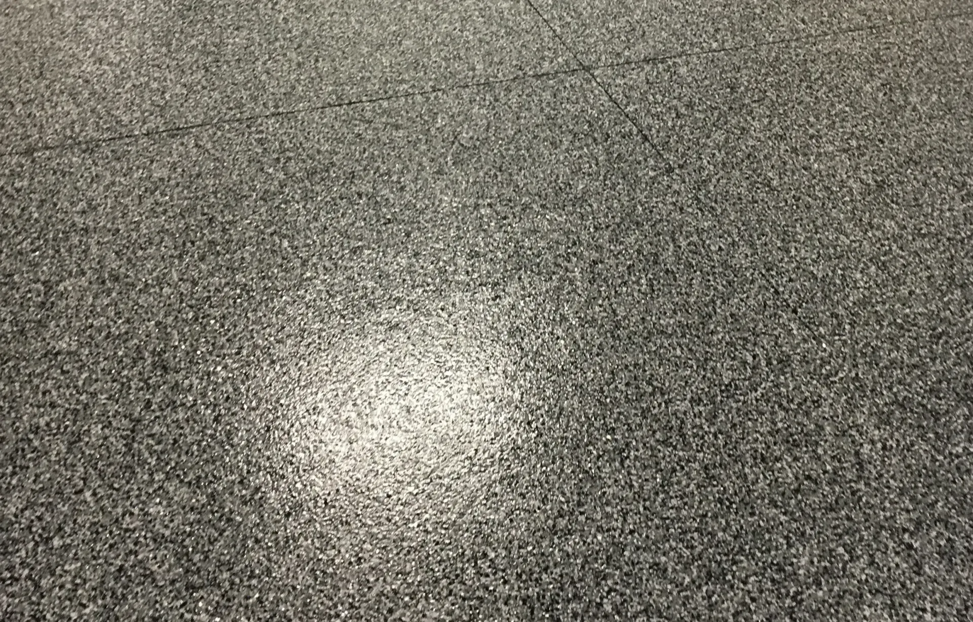 Gray carpet with a bright spot in the center.