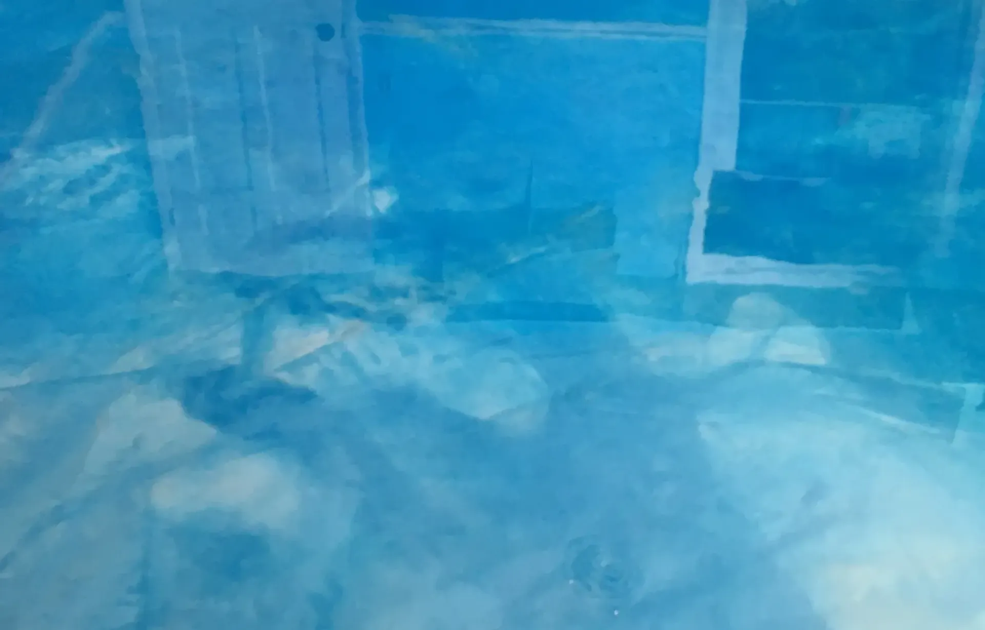 Blue abstract with light reflections, possibly water or ice.