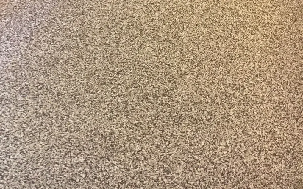 Granite countertop with speckled beige and gray tones.