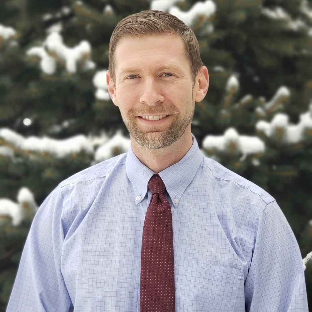 A person icon in a blue circle on a white background.