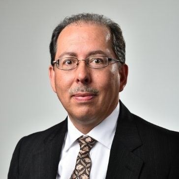 A person icon in a blue circle on a white background.