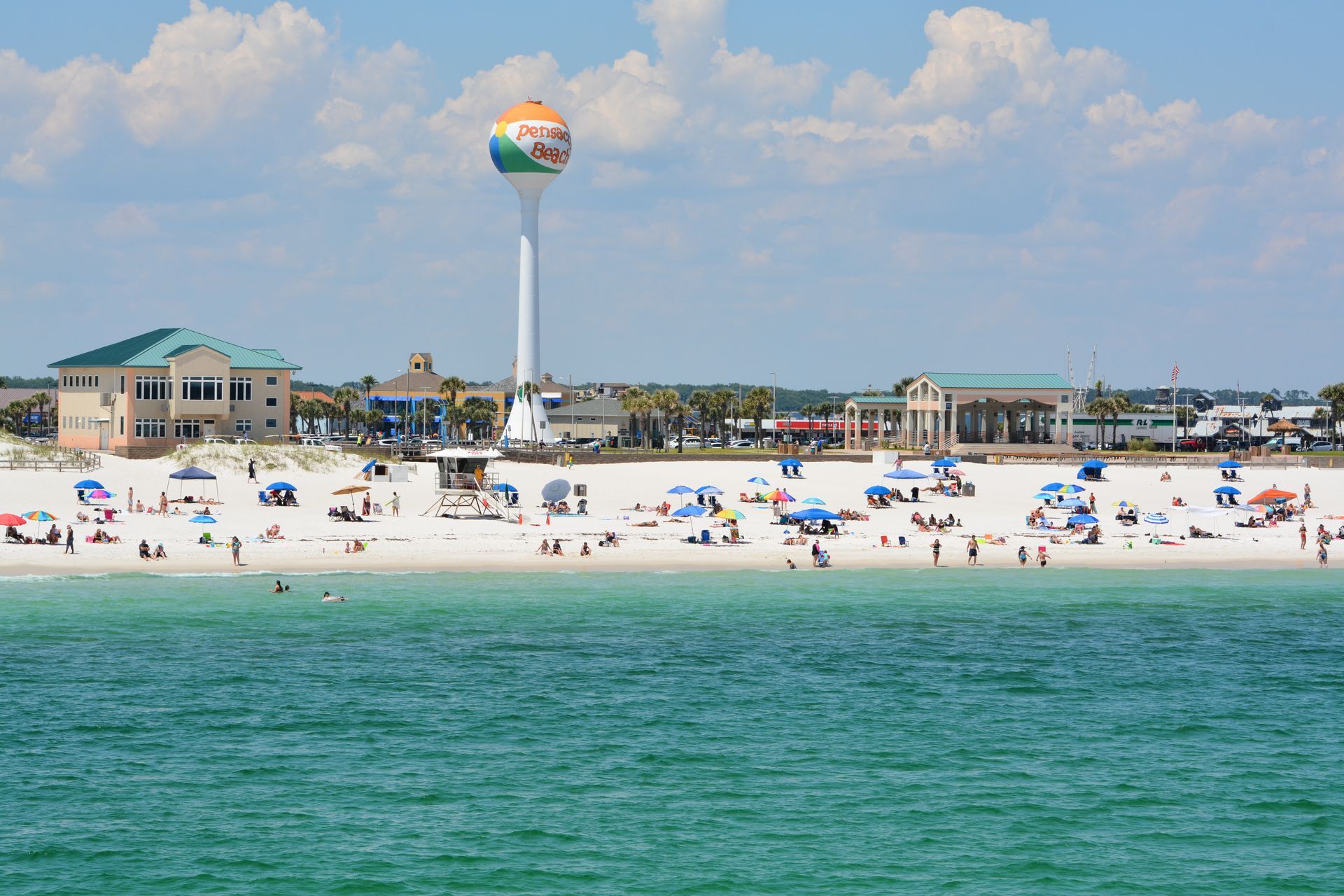 A beach with a water tower in the background