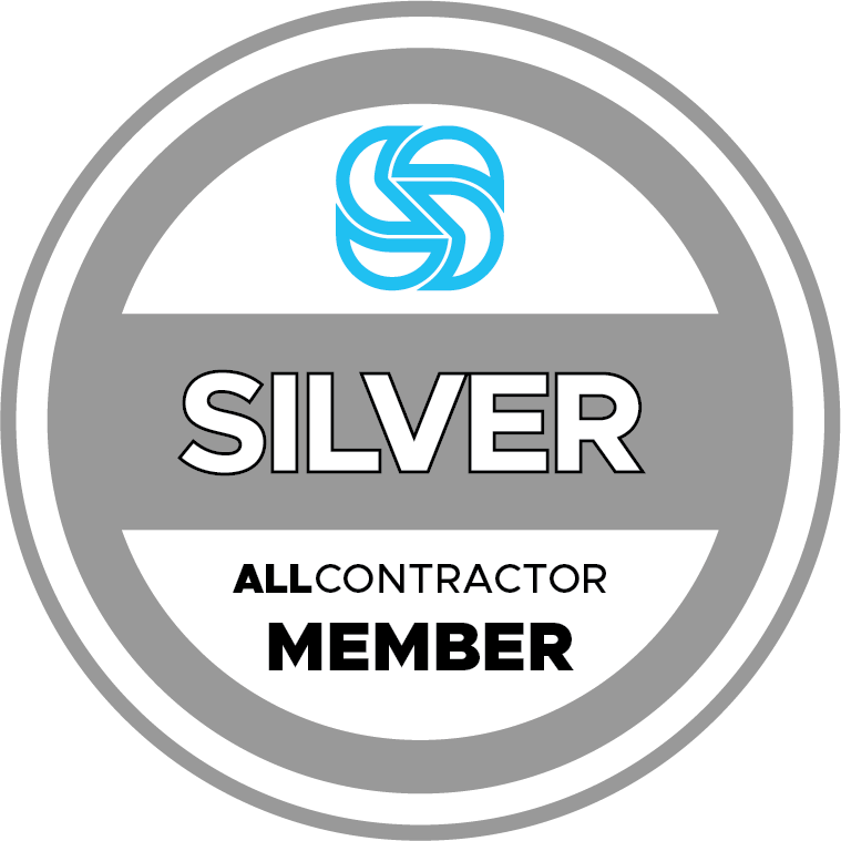 A silver all contractor member badge with a blue s on it