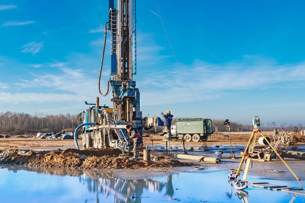 A drill is being used to drill a hole in the ground.