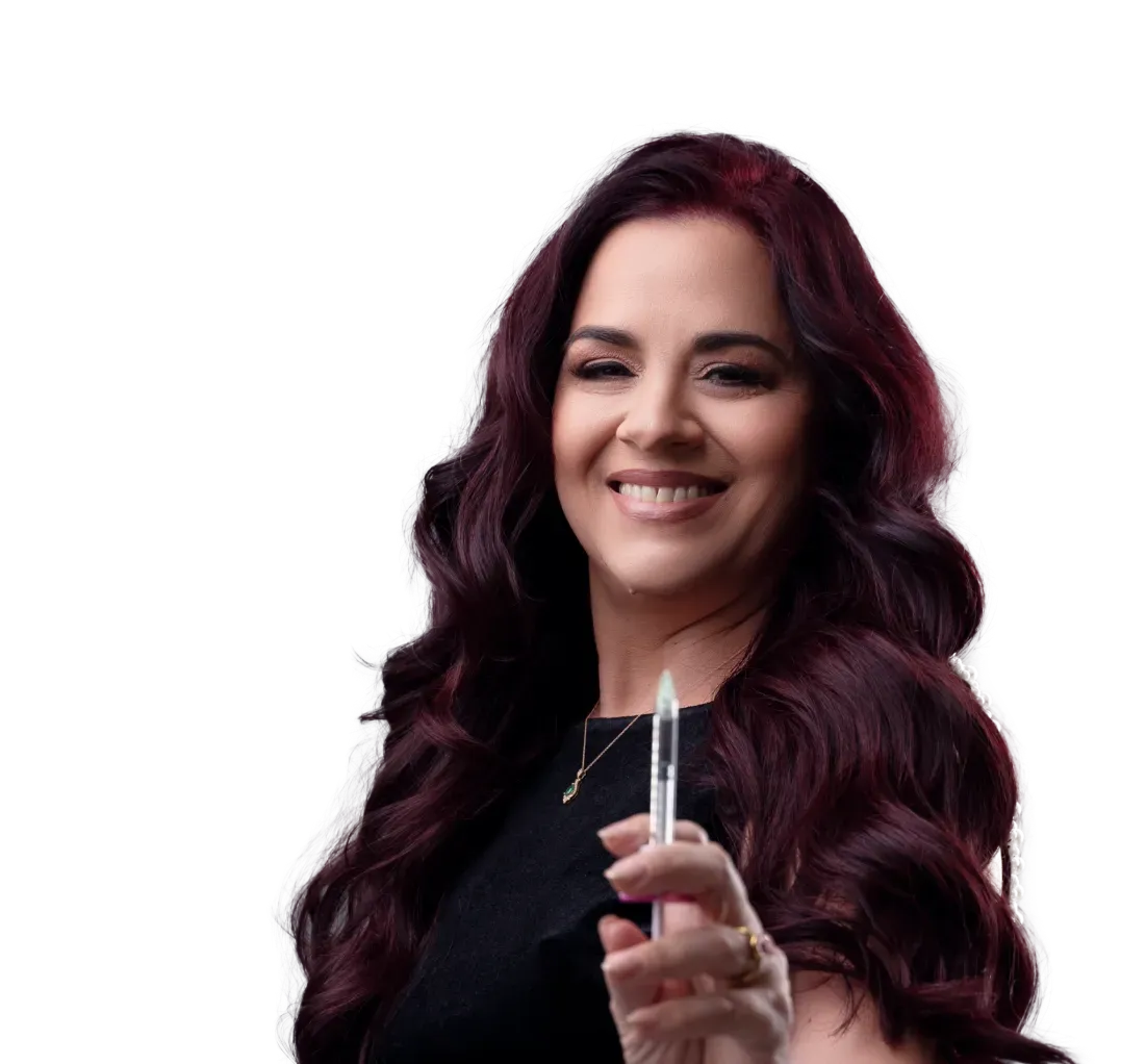 Woman with burgundy hair, smiling, holding pen-like object, isolated on white background.