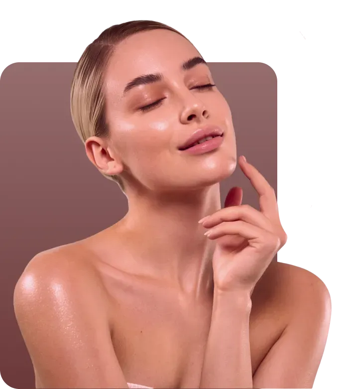 Woman with eyes closed, touching her face, with glowing skin.