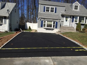 A driveway is being built in front of a house.