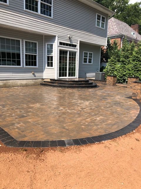A large house with a circular patio in front of it.