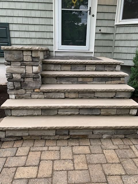 A set of stone steps leading up to a house.
