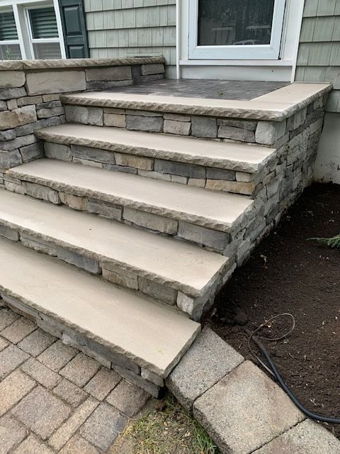 A set of stone steps leading up to a house.