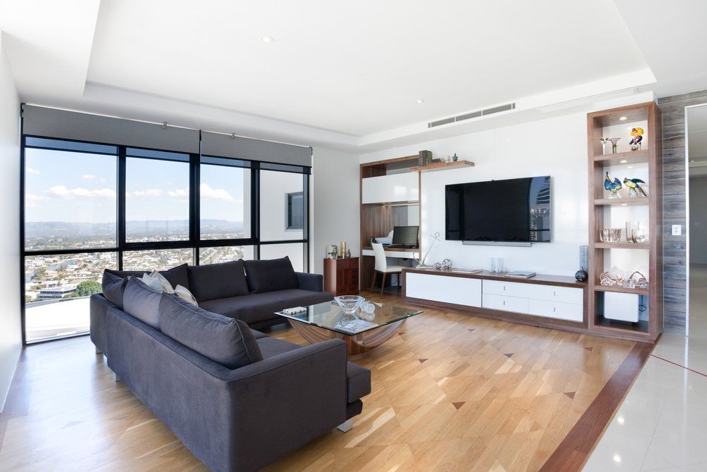 A Living Room With a Couch and a Flat Screen TV — Coffs Coast Antenna Services in Eungai Creek, NSW
