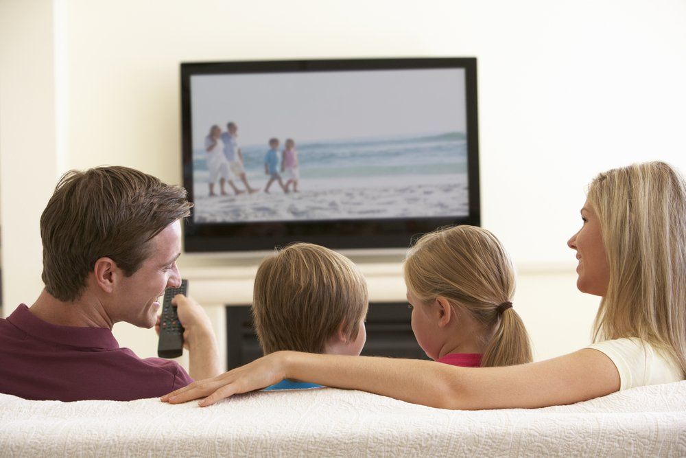 Family watching TV — Coffs Coast Antenna Services in Eungai Creek, NSW