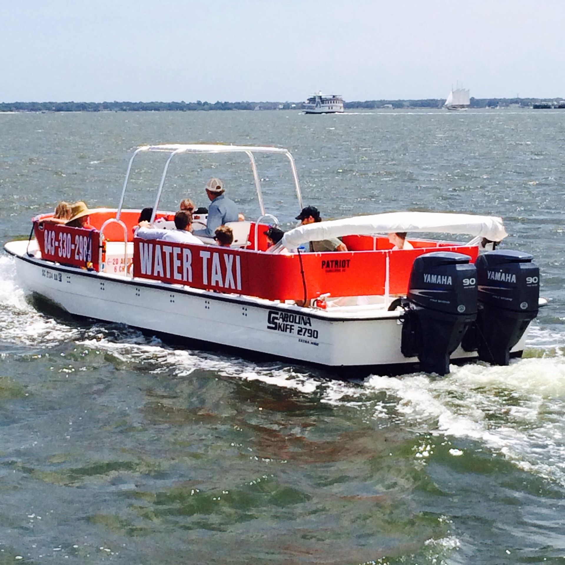 A boat that says water taxi on the side of it