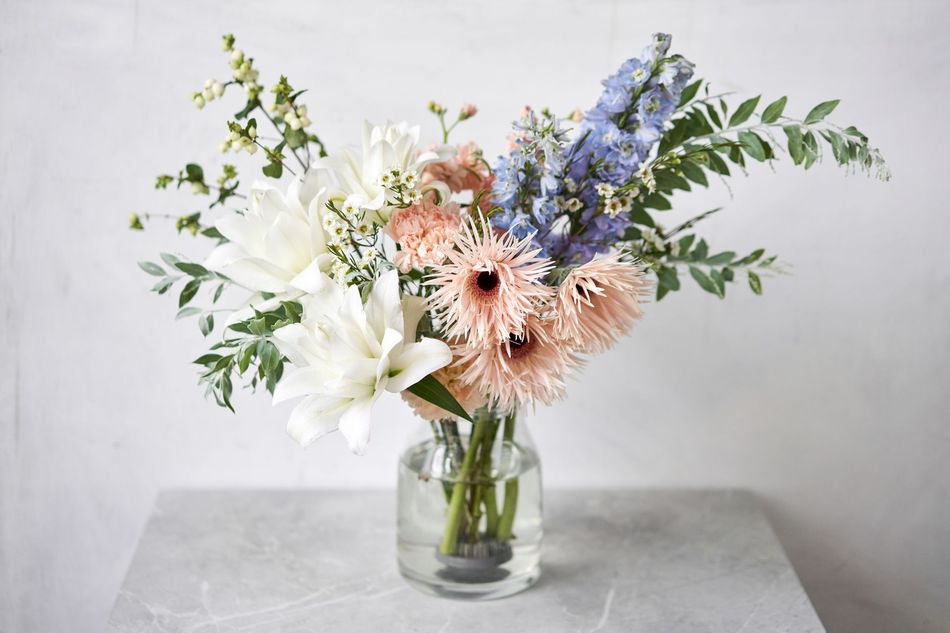 A vase filled with flowers is sitting on a table.