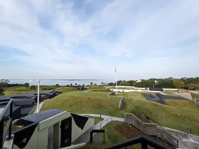 An aerial view of a military base with a flag in the distance.