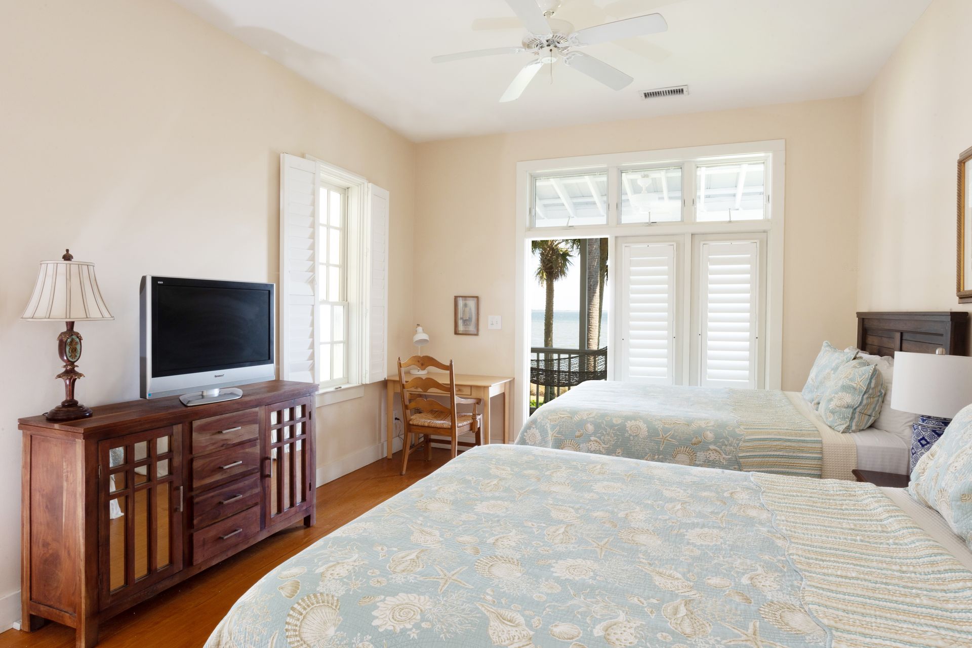 Second bedroom with two queen beds and access to the screened in porch.